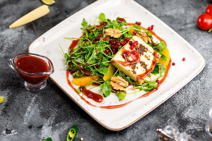 Fried halloumi cheese on a basis of arugula with Cowberry sauce Tamaki